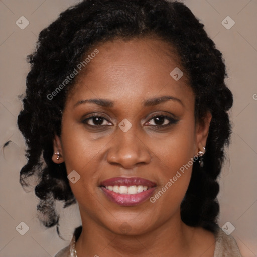 Joyful black young-adult female with long  brown hair and brown eyes