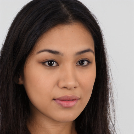 Joyful latino young-adult female with long  brown hair and brown eyes
