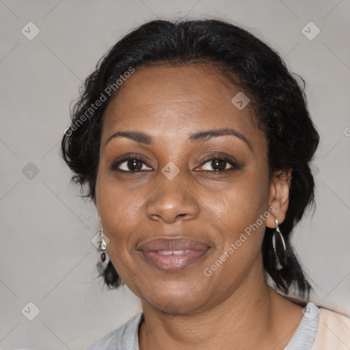 Joyful black adult female with medium  black hair and brown eyes