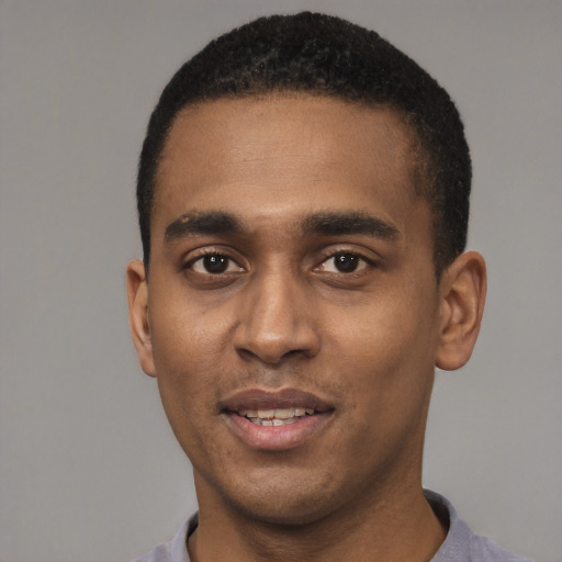 Joyful black young-adult male with short  black hair and brown eyes