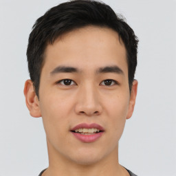 Joyful asian young-adult male with short  black hair and brown eyes