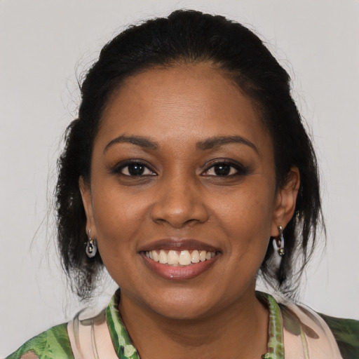 Joyful black young-adult female with medium  brown hair and brown eyes