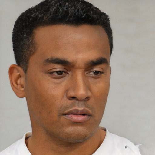 Neutral latino young-adult male with short  black hair and brown eyes