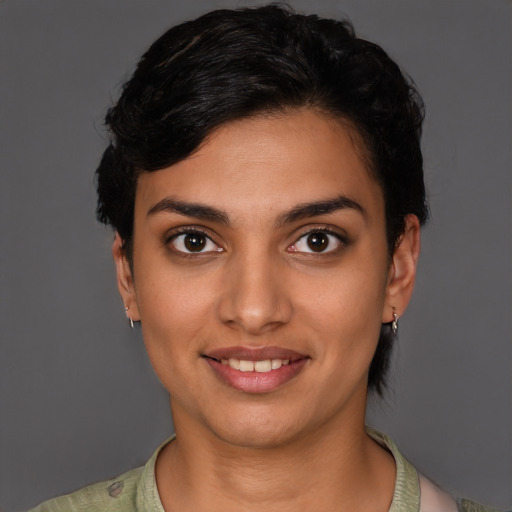 Joyful latino young-adult female with short  brown hair and brown eyes