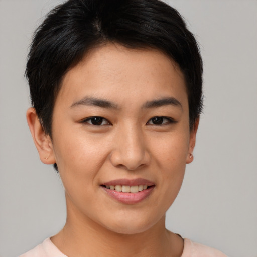 Joyful asian young-adult female with short  brown hair and brown eyes