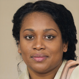 Joyful black young-adult female with medium  brown hair and brown eyes