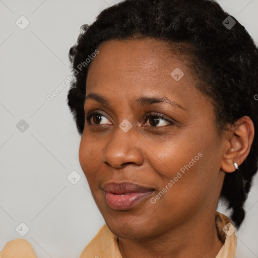 Joyful black adult female with short  brown hair and brown eyes