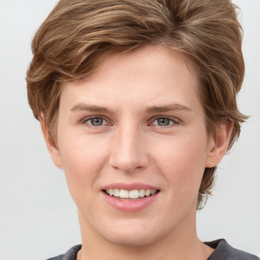 Joyful white young-adult female with medium  brown hair and grey eyes