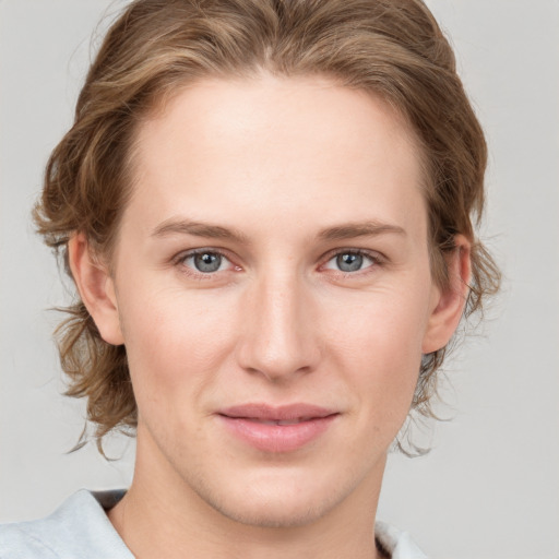 Joyful white young-adult female with medium  brown hair and blue eyes