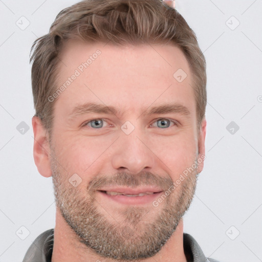 Joyful white adult male with short  brown hair and blue eyes