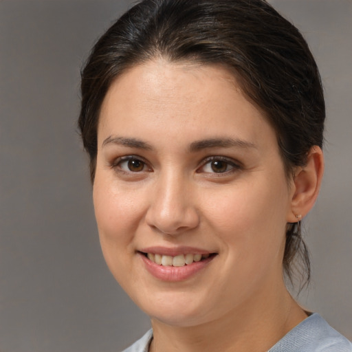 Joyful white young-adult female with medium  brown hair and brown eyes