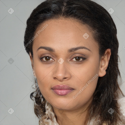 Joyful black young-adult female with long  brown hair and brown eyes