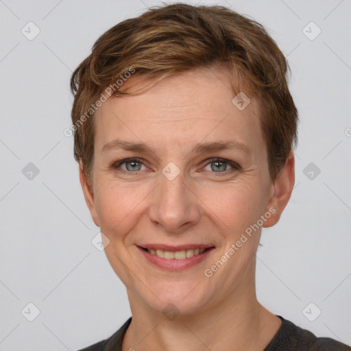 Joyful white adult female with short  brown hair and grey eyes