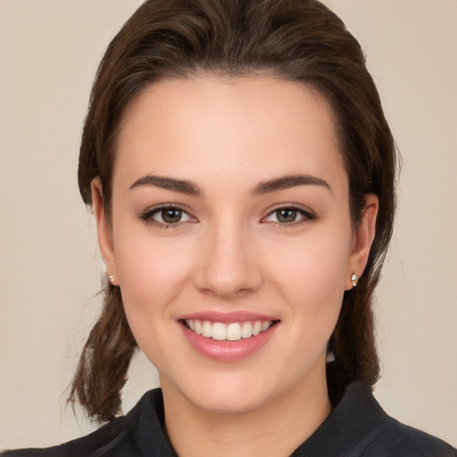 Joyful white young-adult female with medium  brown hair and brown eyes