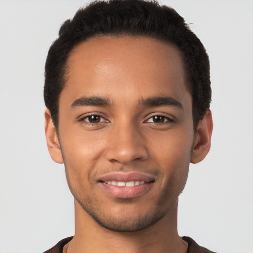 Joyful latino young-adult male with short  brown hair and brown eyes