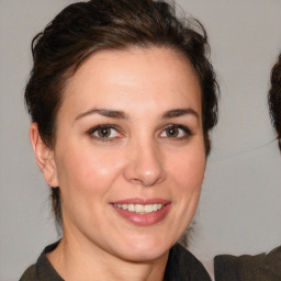 Joyful white adult female with medium  brown hair and brown eyes