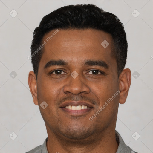 Joyful latino young-adult male with short  black hair and brown eyes