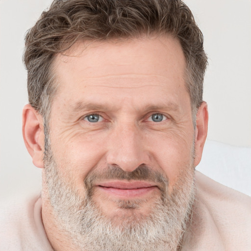 Joyful white adult male with short  brown hair and grey eyes