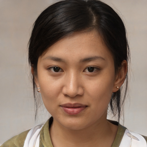Joyful asian young-adult female with medium  brown hair and brown eyes