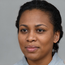 Joyful black young-adult female with medium  brown hair and brown eyes