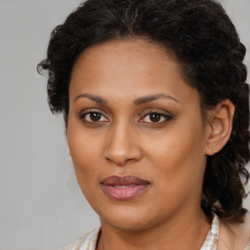 Joyful black young-adult female with medium  brown hair and brown eyes