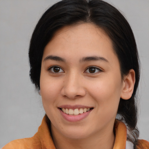 Joyful asian young-adult female with medium  brown hair and brown eyes