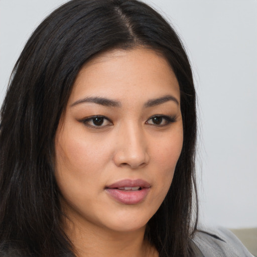 Joyful asian young-adult female with long  brown hair and brown eyes