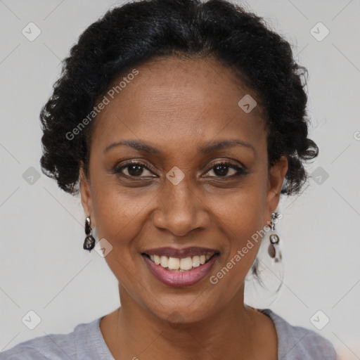 Joyful black adult female with short  brown hair and brown eyes