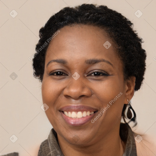 Joyful black adult female with long  brown hair and brown eyes