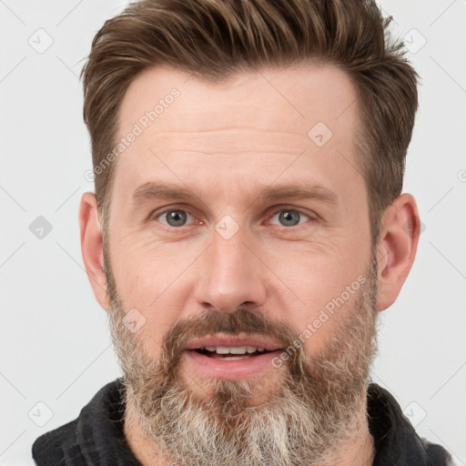 Joyful white adult male with short  brown hair and grey eyes