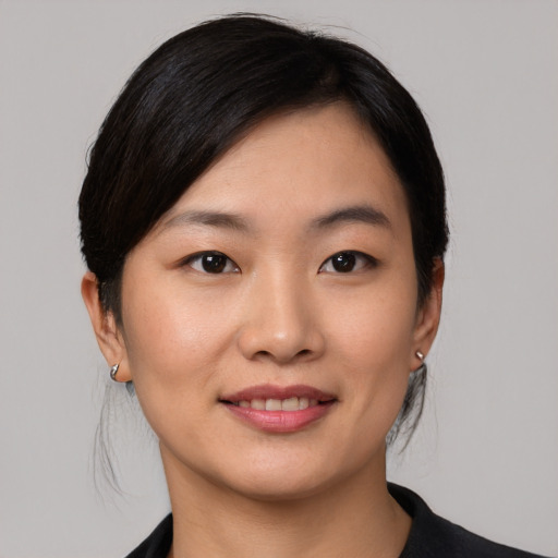 Joyful asian young-adult female with medium  black hair and brown eyes