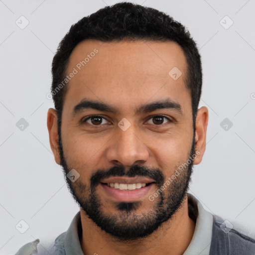 Joyful latino young-adult male with short  black hair and brown eyes