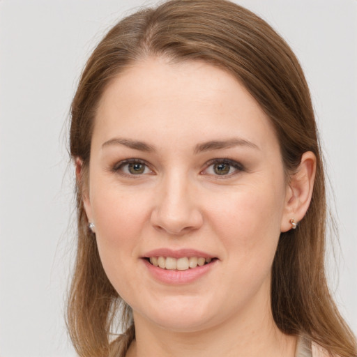 Joyful white young-adult female with long  brown hair and grey eyes