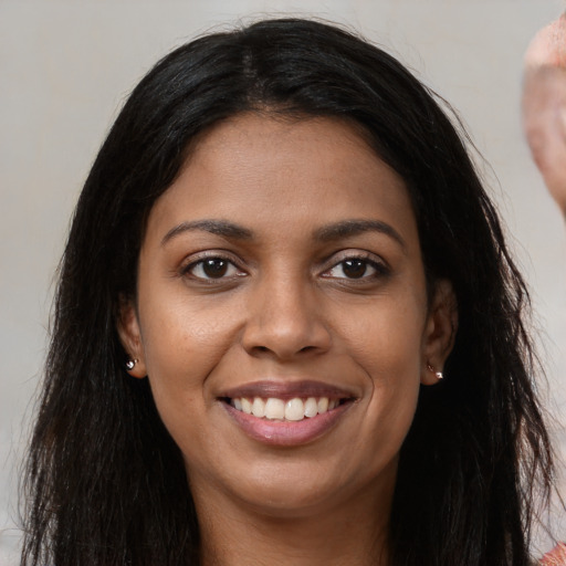 Joyful latino young-adult female with long  brown hair and brown eyes