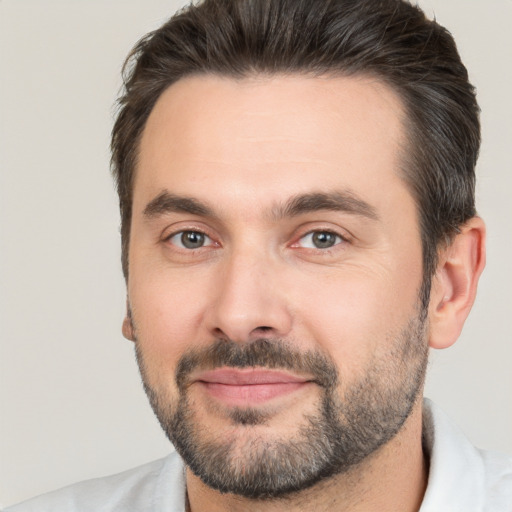 Joyful white adult male with short  brown hair and brown eyes