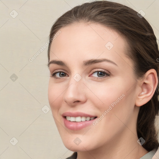 Joyful white young-adult female with medium  brown hair and grey eyes