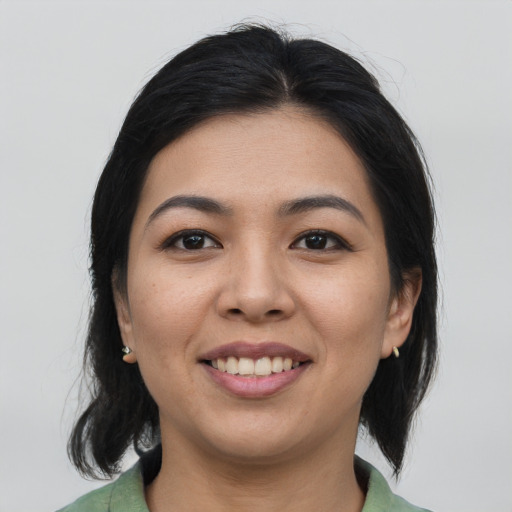 Joyful asian young-adult female with medium  brown hair and brown eyes