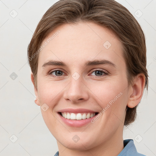 Joyful white young-adult female with short  brown hair and grey eyes