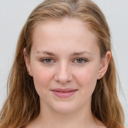 Joyful white young-adult female with long  brown hair and blue eyes