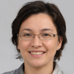 Joyful white adult female with medium  brown hair and brown eyes