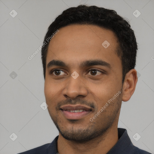 Joyful black young-adult male with short  black hair and brown eyes