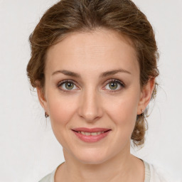 Joyful white young-adult female with medium  brown hair and green eyes