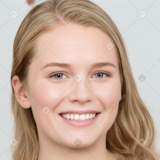 Joyful white young-adult female with long  brown hair and blue eyes