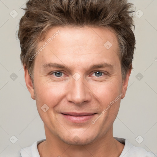 Joyful white adult male with short  brown hair and grey eyes