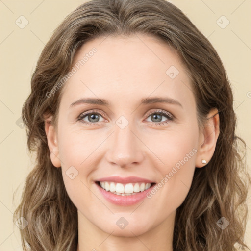 Joyful white young-adult female with long  brown hair and green eyes