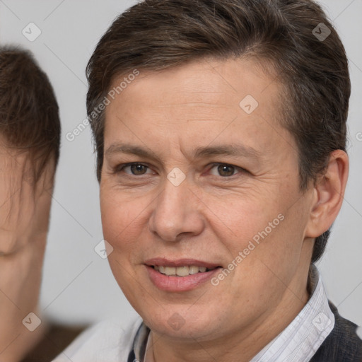 Joyful white adult female with short  brown hair and brown eyes