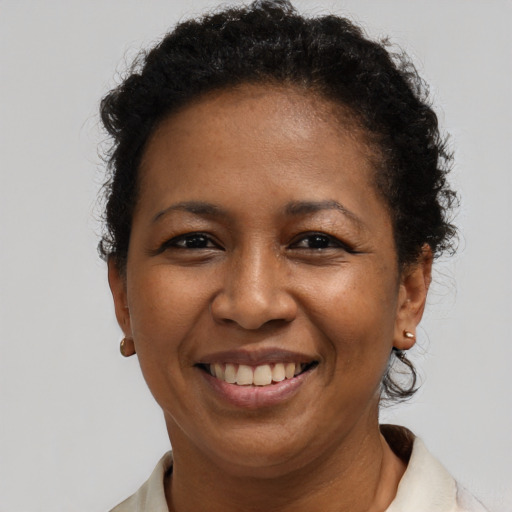 Joyful black adult female with short  brown hair and brown eyes