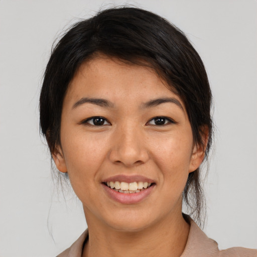Joyful asian young-adult female with medium  brown hair and brown eyes