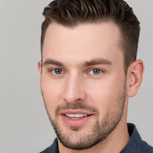 Joyful white young-adult male with short  brown hair and brown eyes