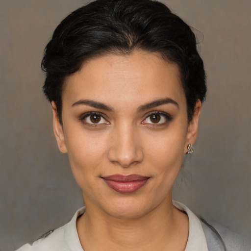 Joyful latino young-adult female with short  brown hair and brown eyes